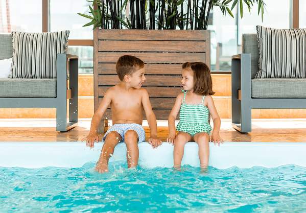 Kids at indoor pool at Four Seasons Hotel Boston