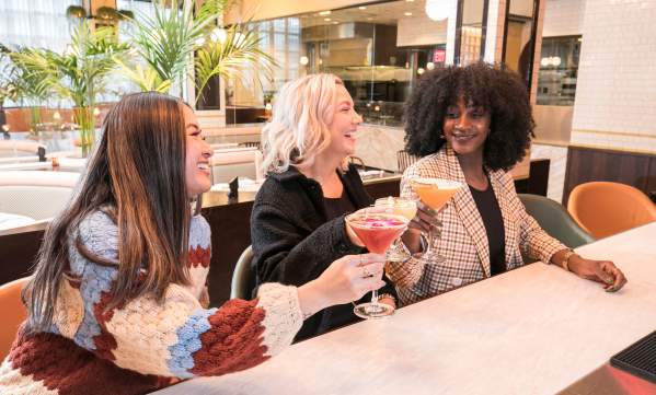 Three friends grabbing drinks during Dine Out Boston