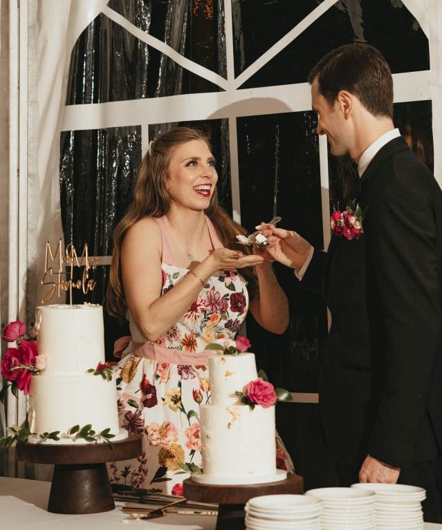 a bride and groom enjoying their wedding cake