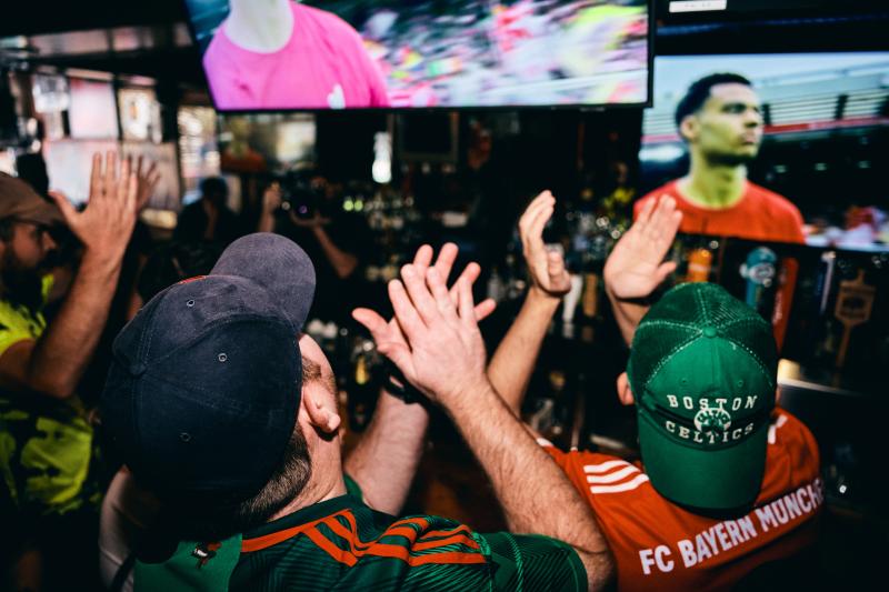 Crowd watching soccer at a Boston sports bar